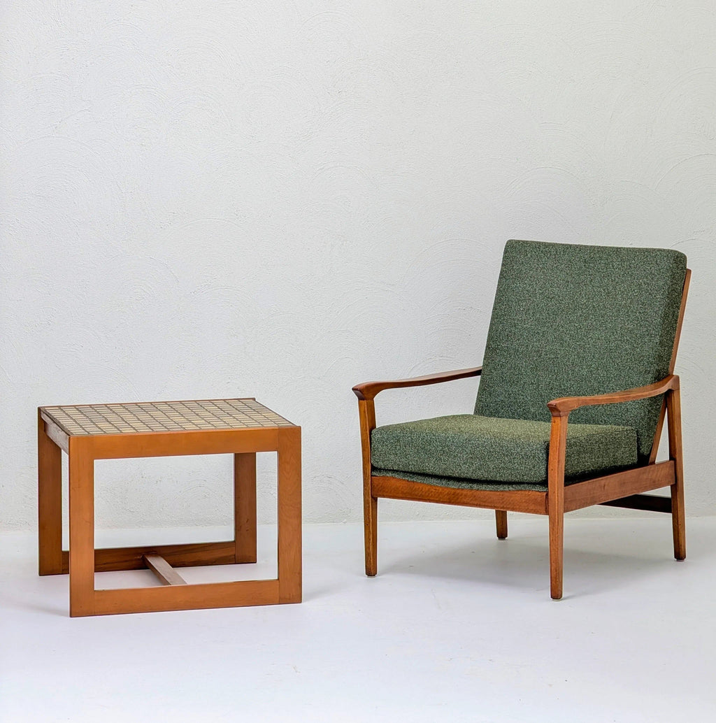 Mid-century modern green armchair with wooden frame and matching wooden side table with tiled top