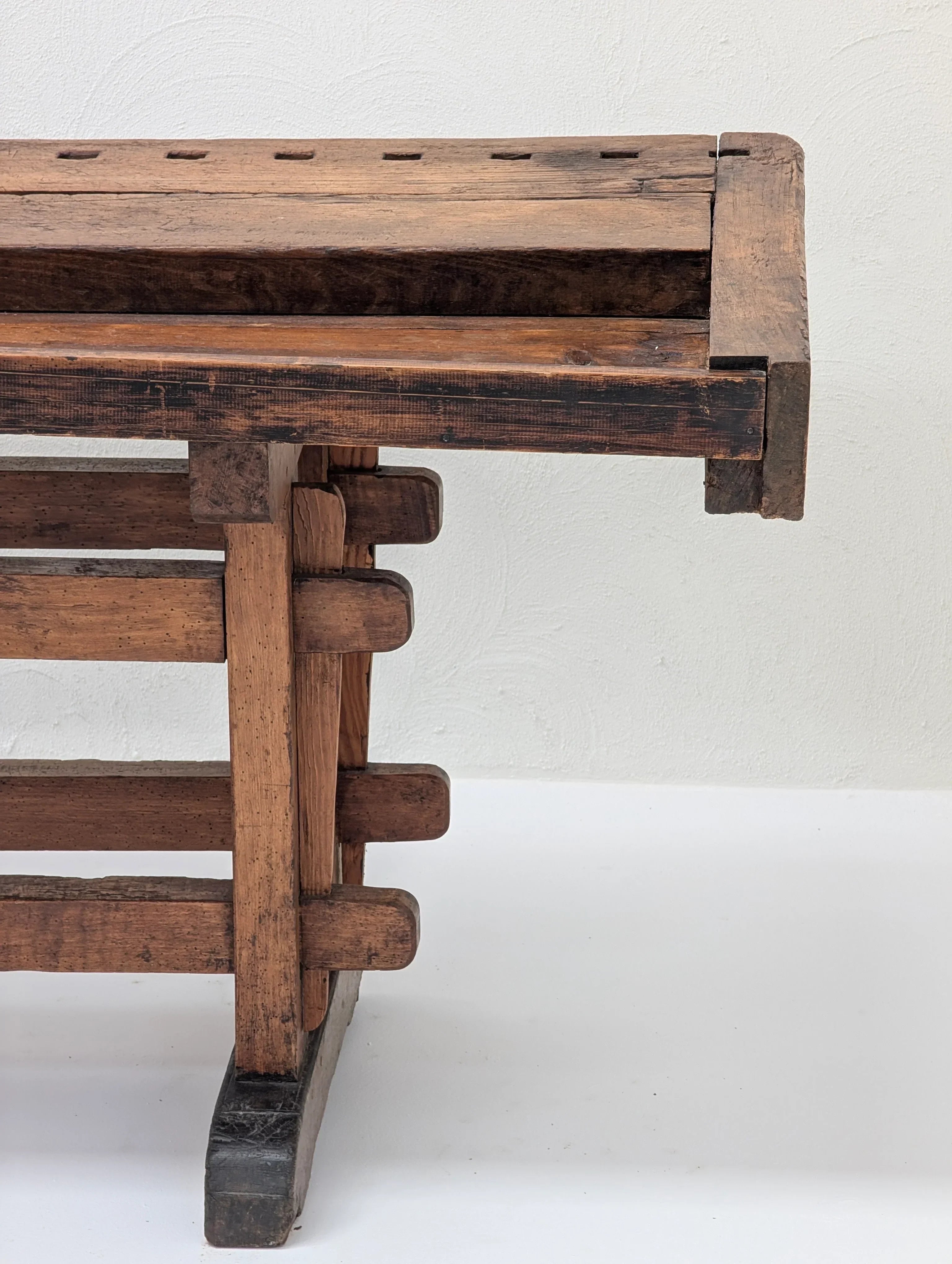 Vintage wooden workbench leg with dovetail joints on white background