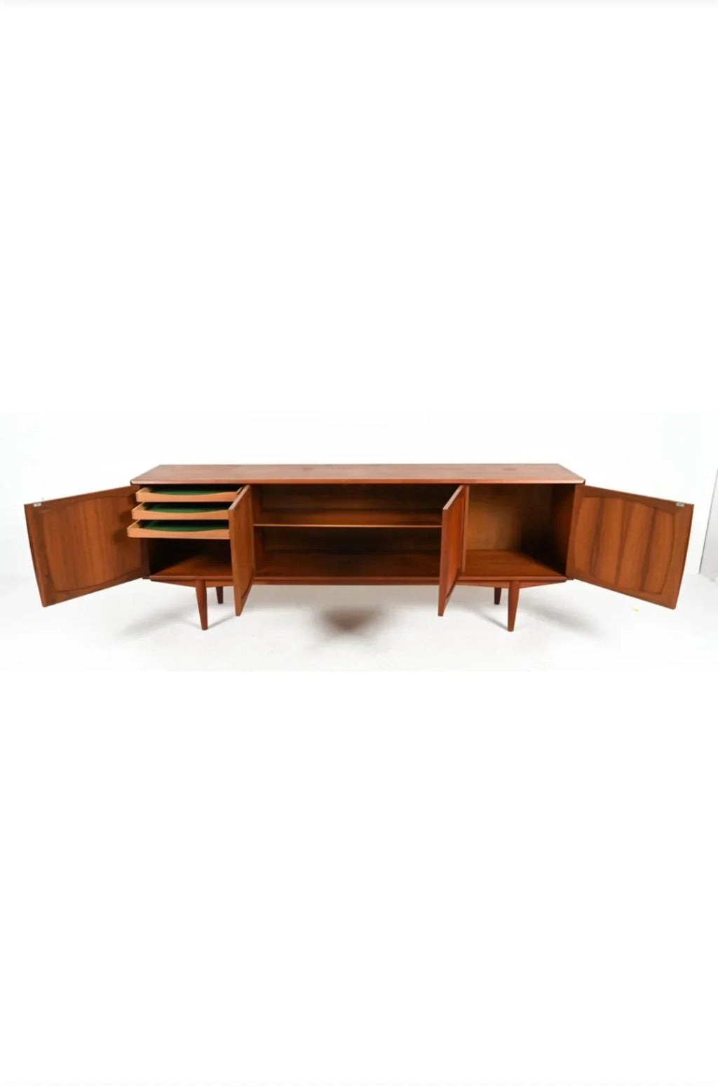 Mid-century modern wooden sideboard with open doors and shelves on white background
