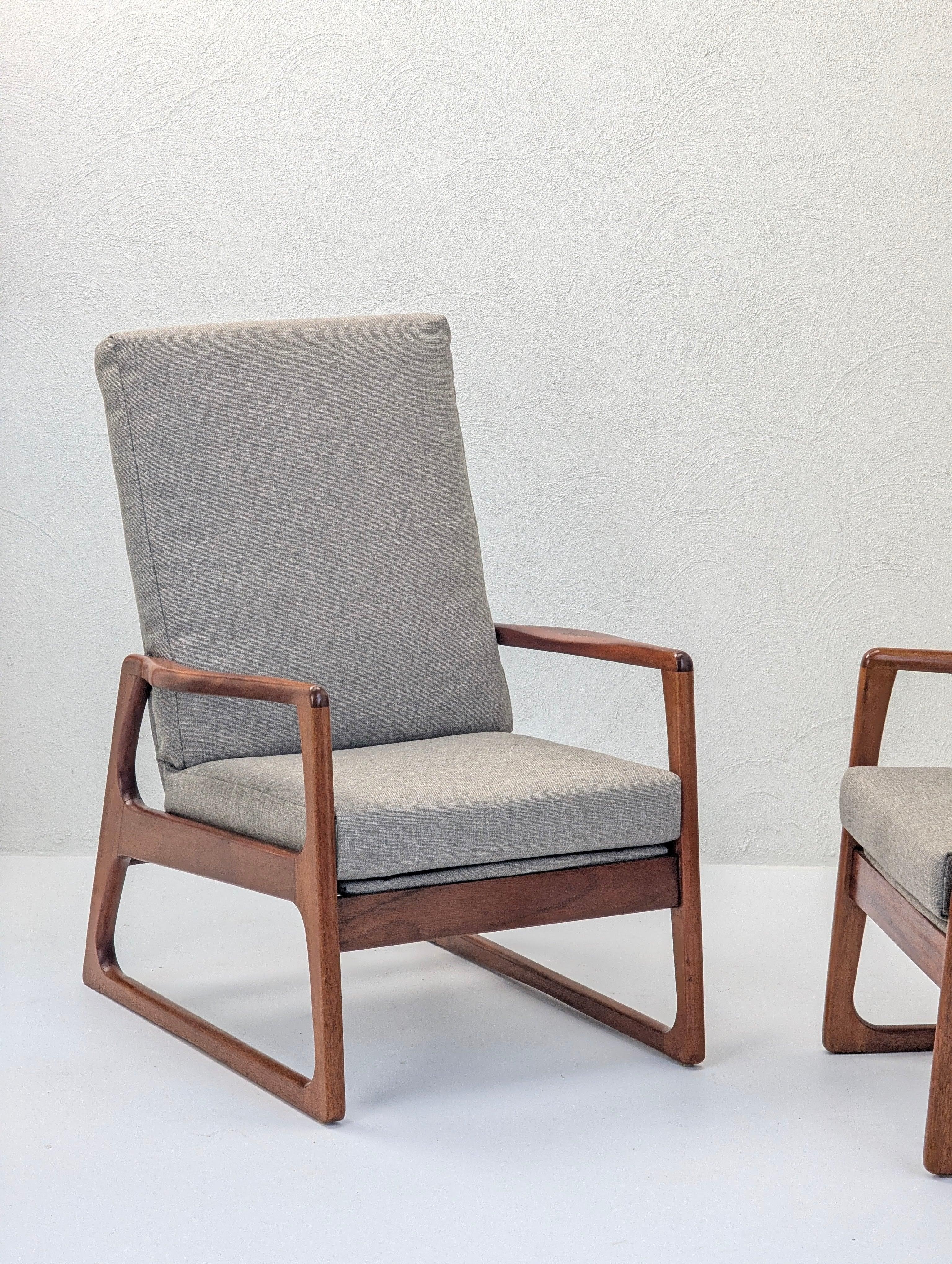 Mid-century modern lounge chair with wooden frame and gray upholstered cushions