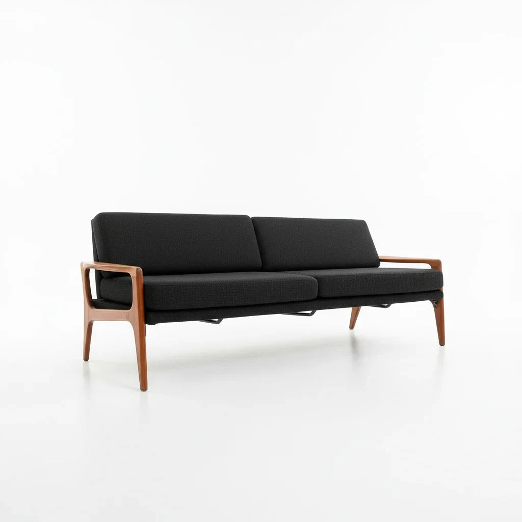 Mid-century modern black fabric sofa with wooden frame on white background