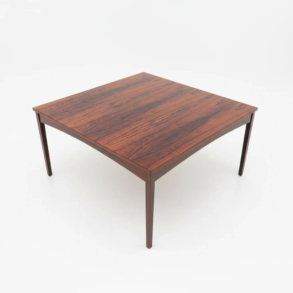 Mid-century modern square rosewood coffee table with tapered legs on white background