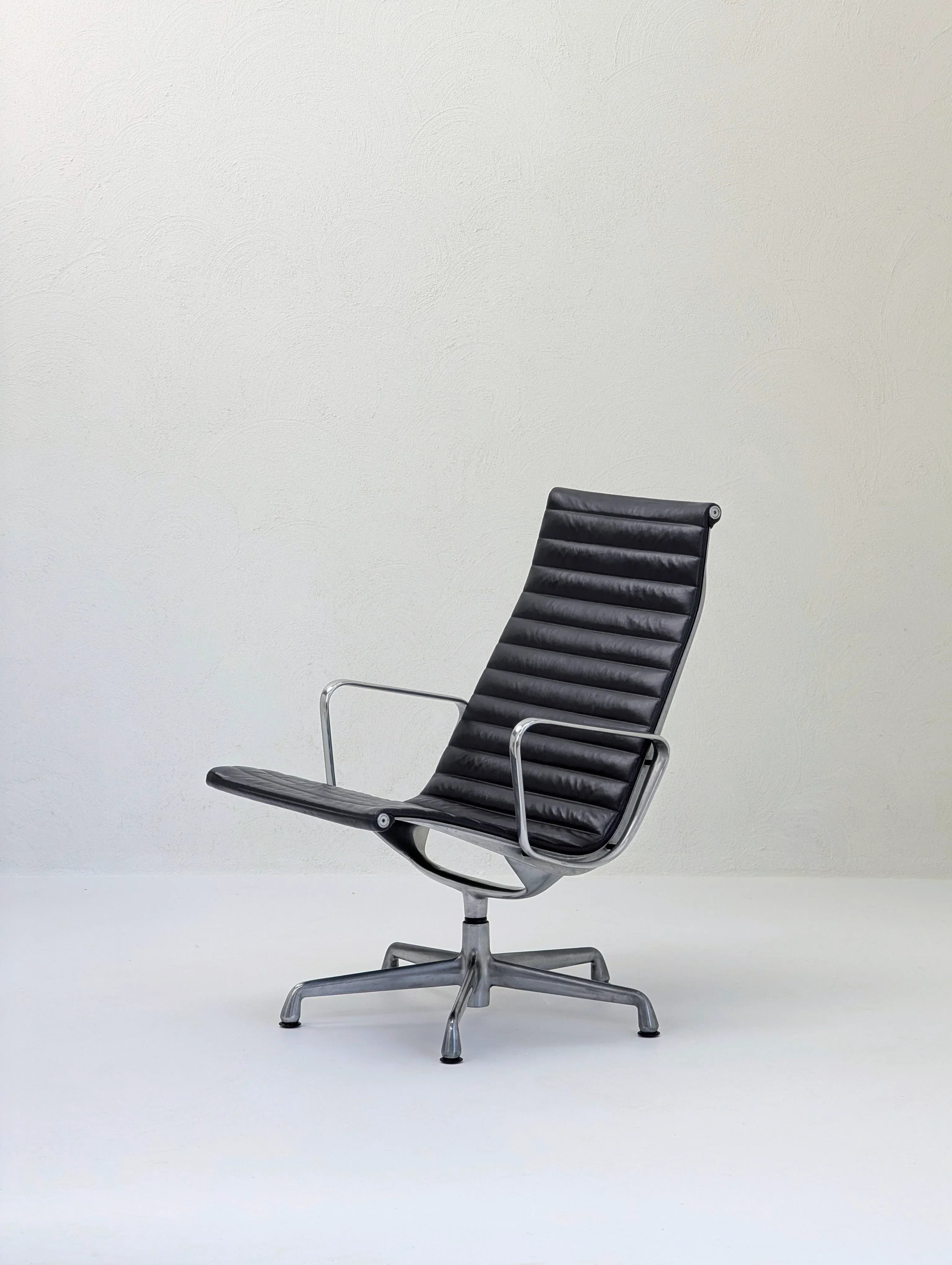 Modern black leather office chair with metal frame in minimalist setting