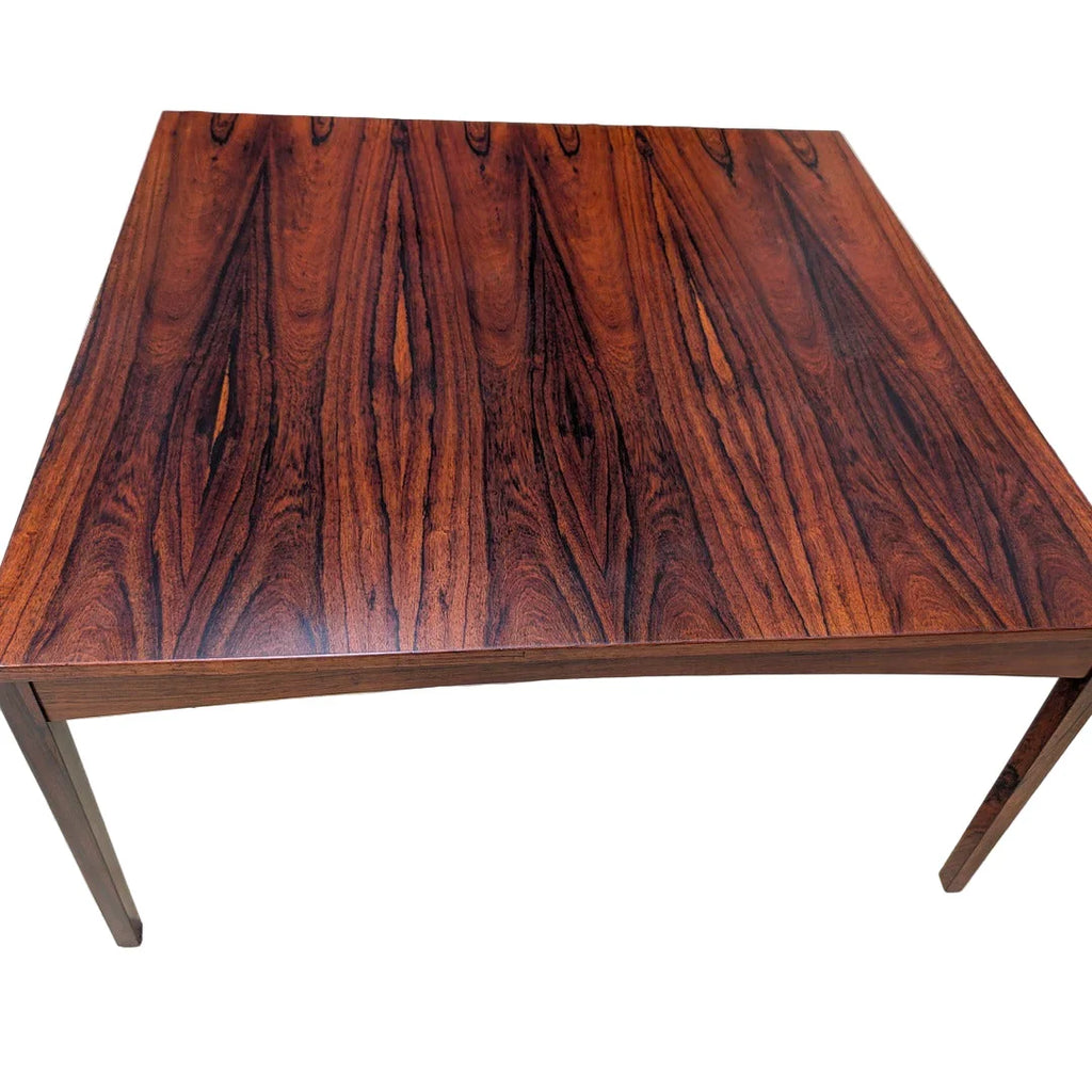 Square rosewood dining table with rich wood grain on white background