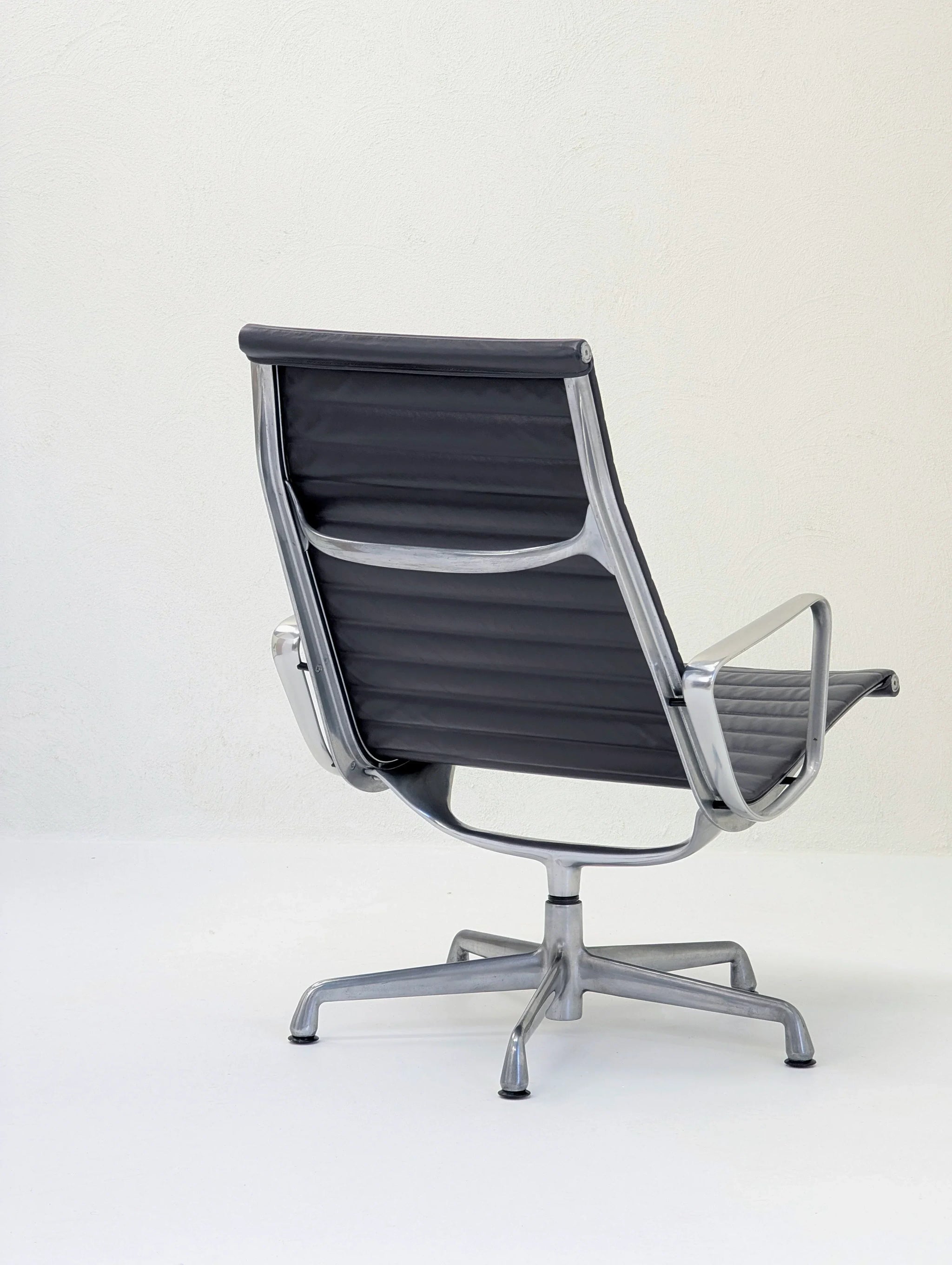 Modern black office chair with metal frame and swivel base on white background