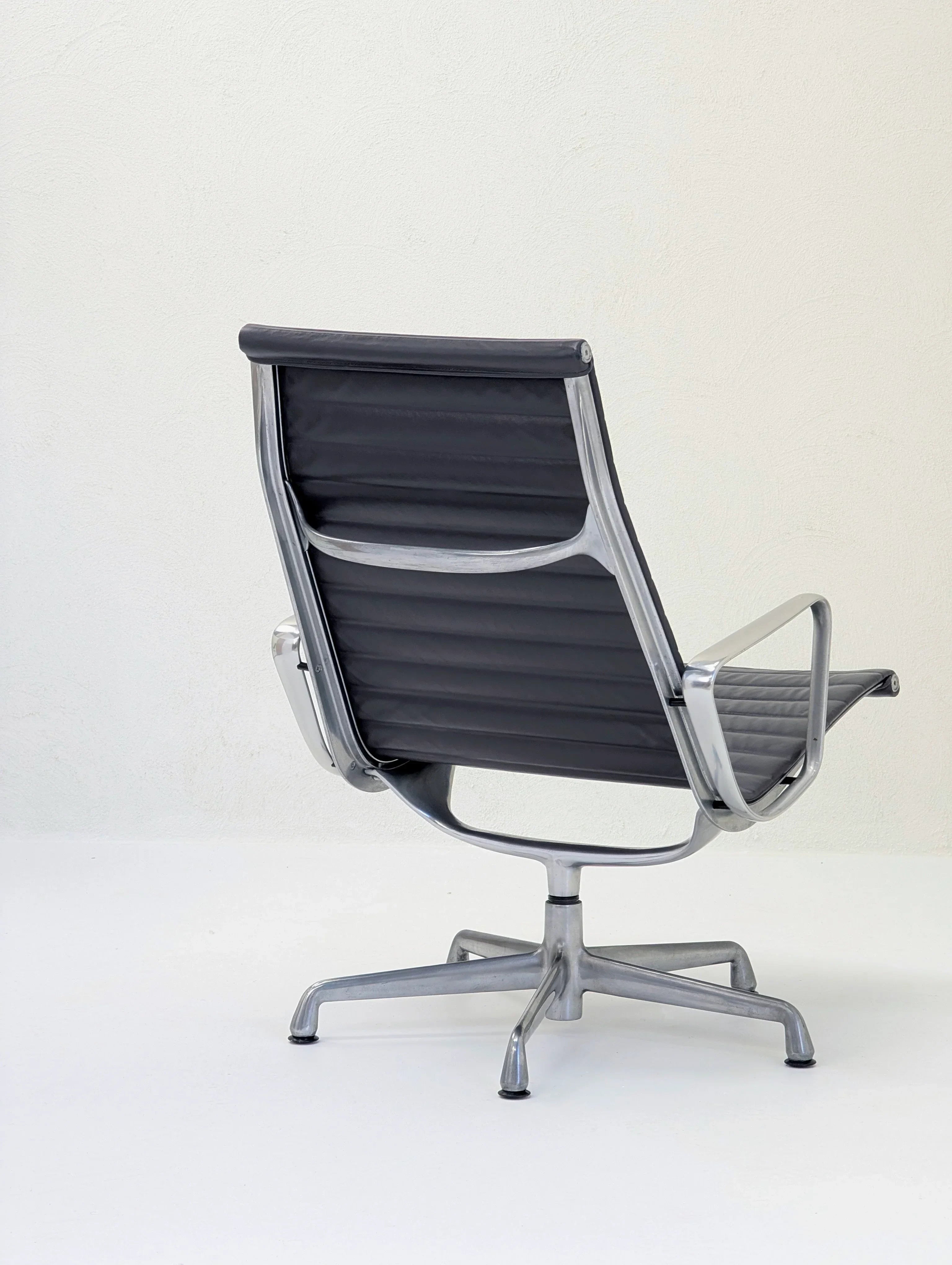 Modern black office chair with metal frame and swivel base on white background
