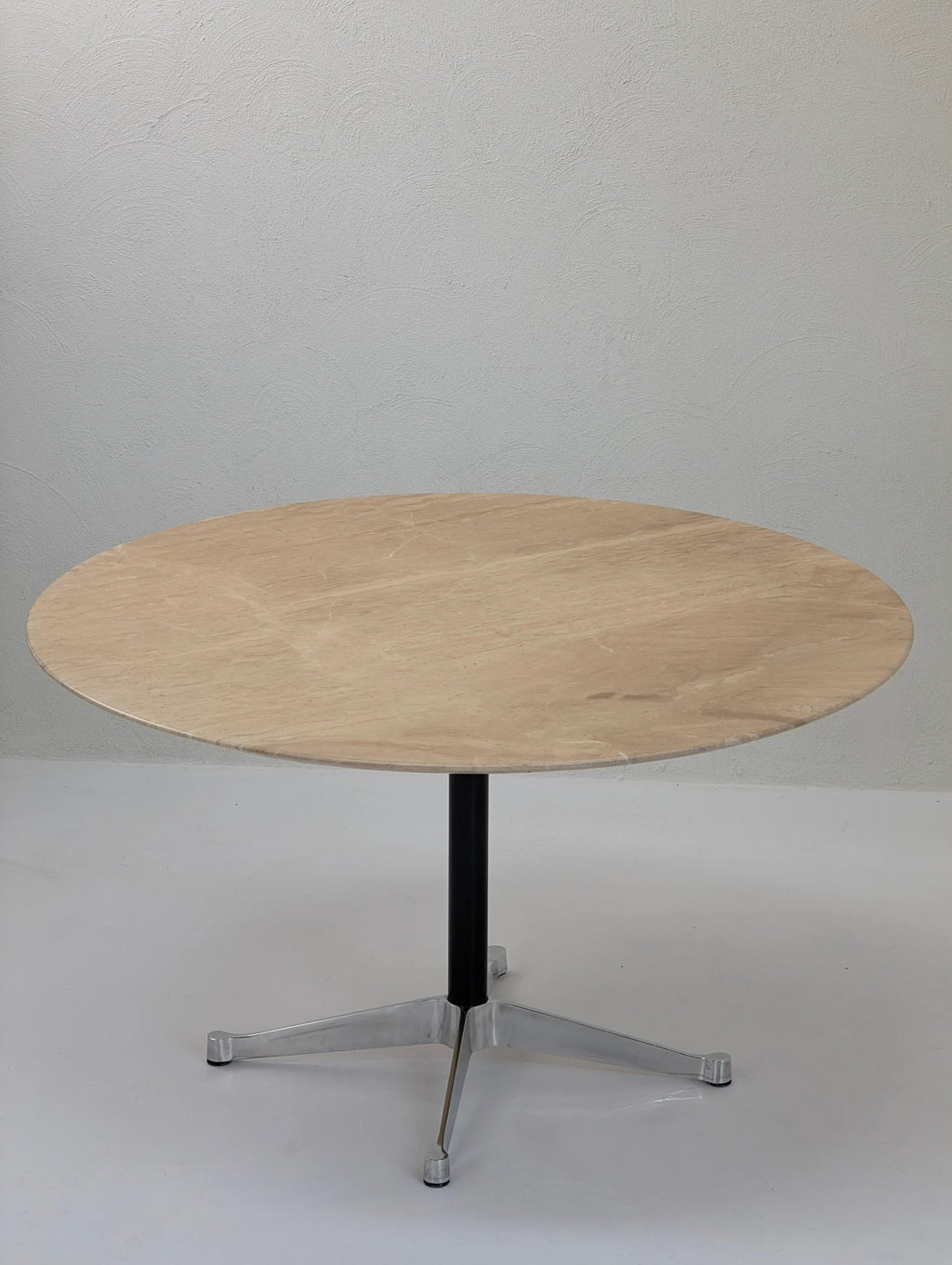 Round wooden table with metal pedestal base on white background