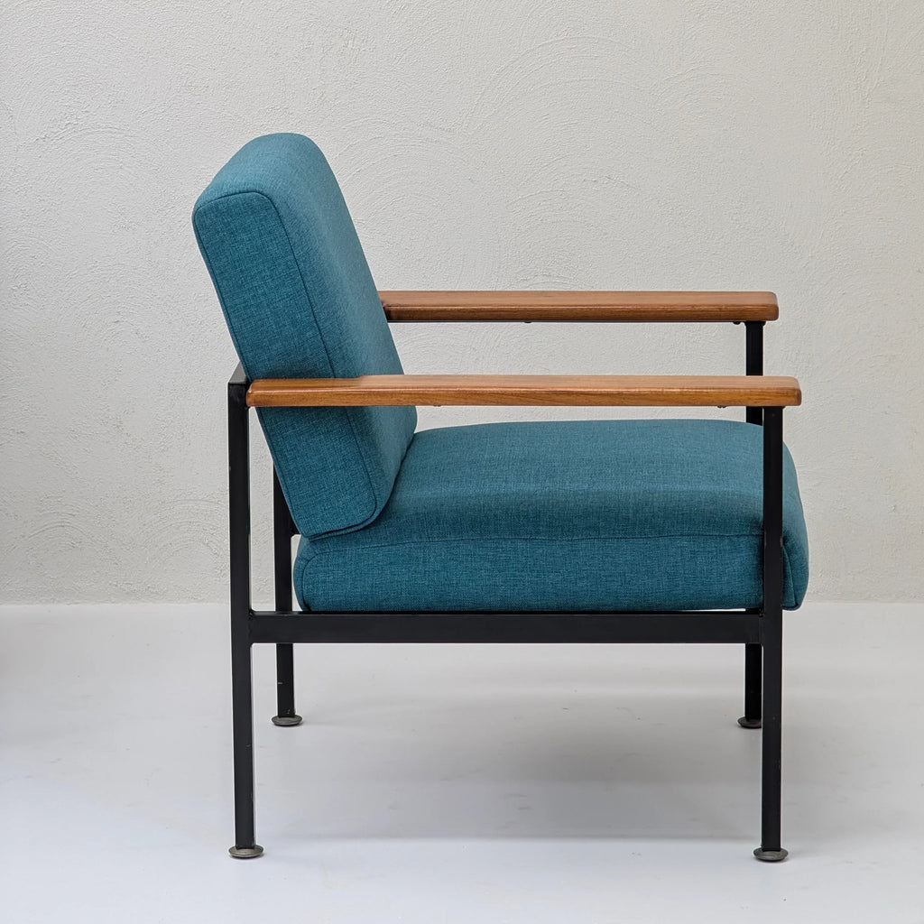 Modern lounge chair with teal upholstery, black metal frame, and wooden armrests