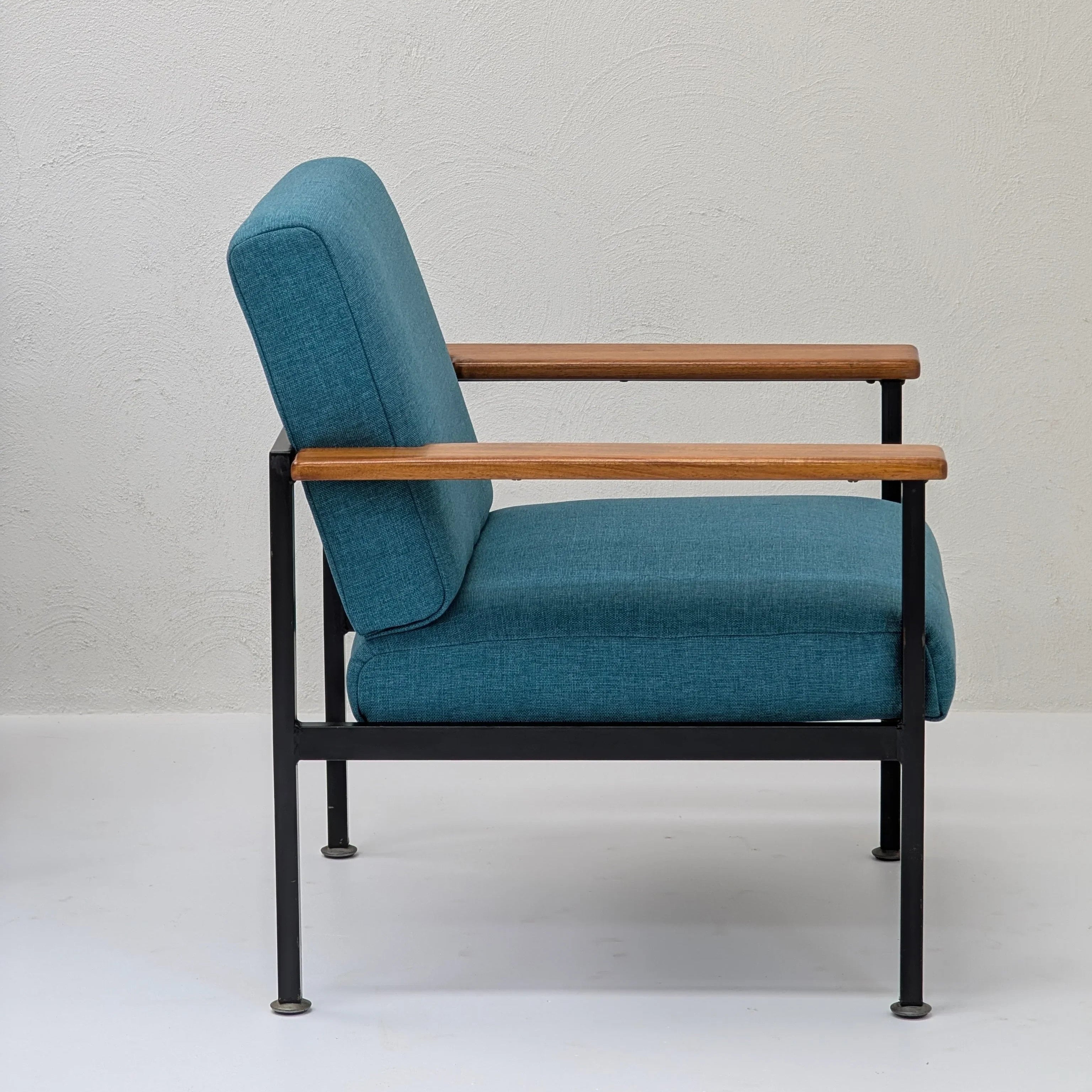 Modern lounge chair with teal upholstery, black metal frame, and wooden armrests