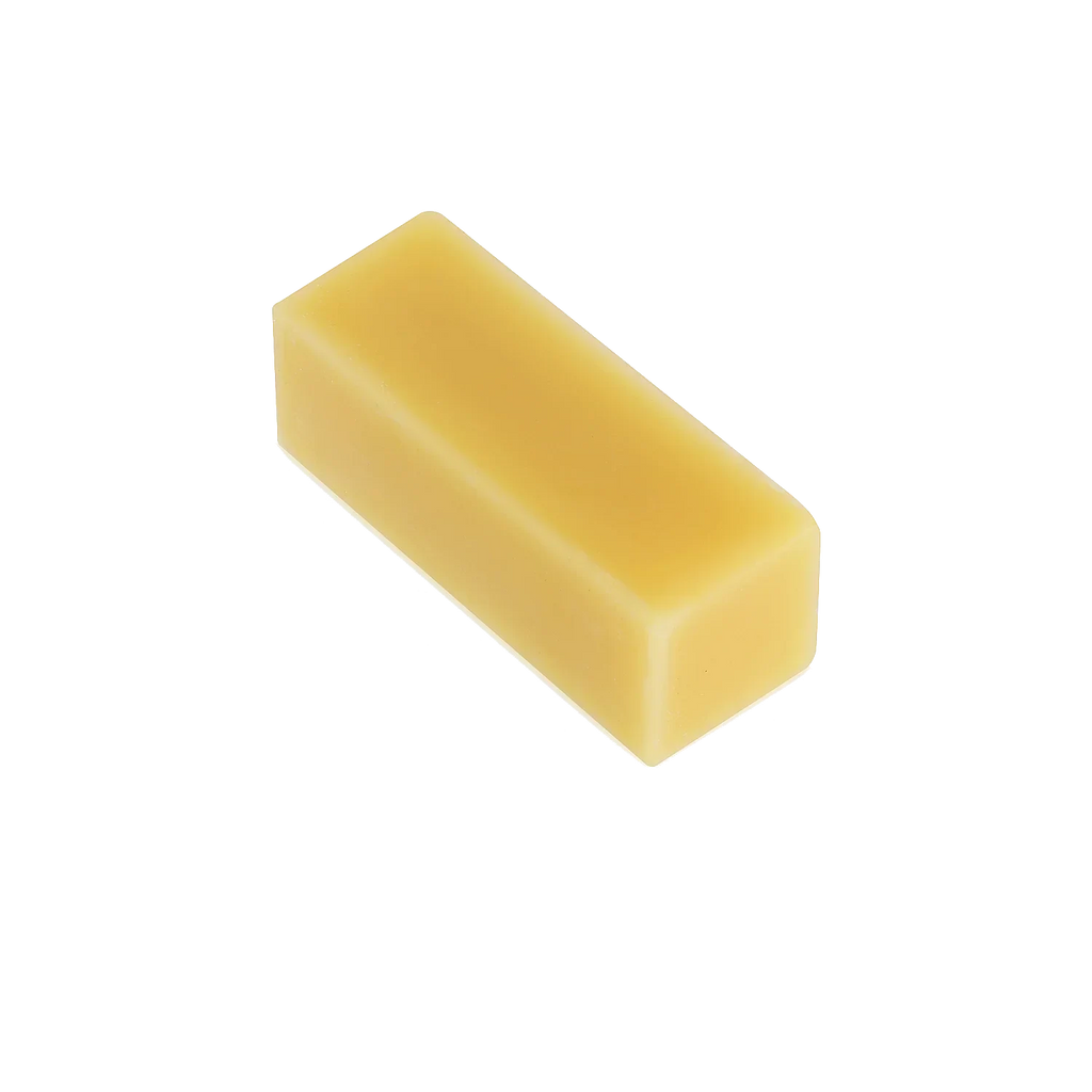 Rectangular yellow beeswax bar on white background