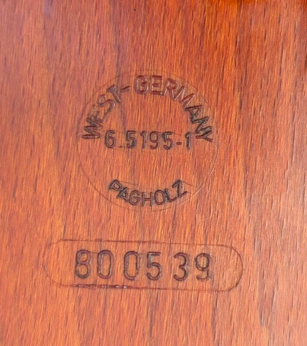 Wooden surface close-up with engraved stamps reading West-Germany, Pagholz, and number 800539
