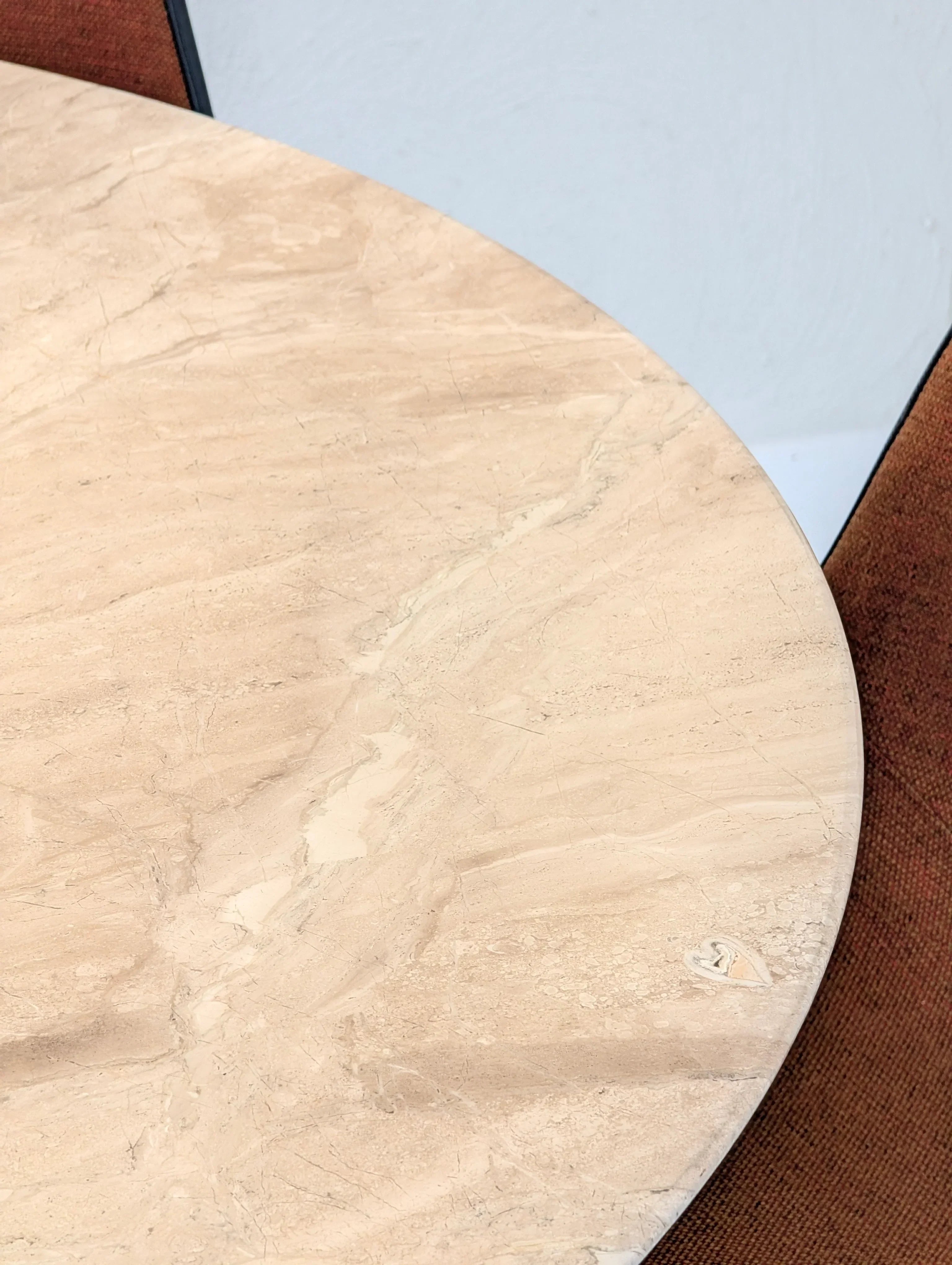 Round beige marble table with brown fabric chairs, modern dining room furniture