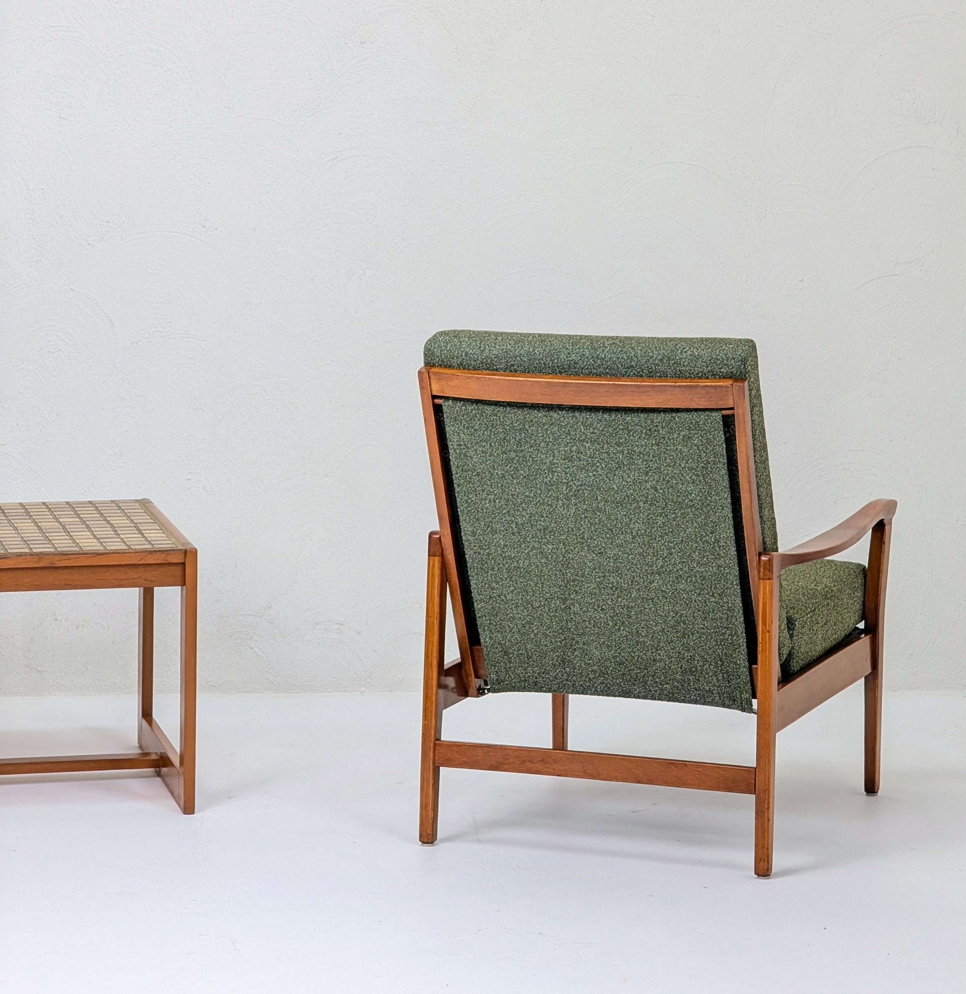Mid-century modern wooden armchair with green upholstery and matching wooden side table