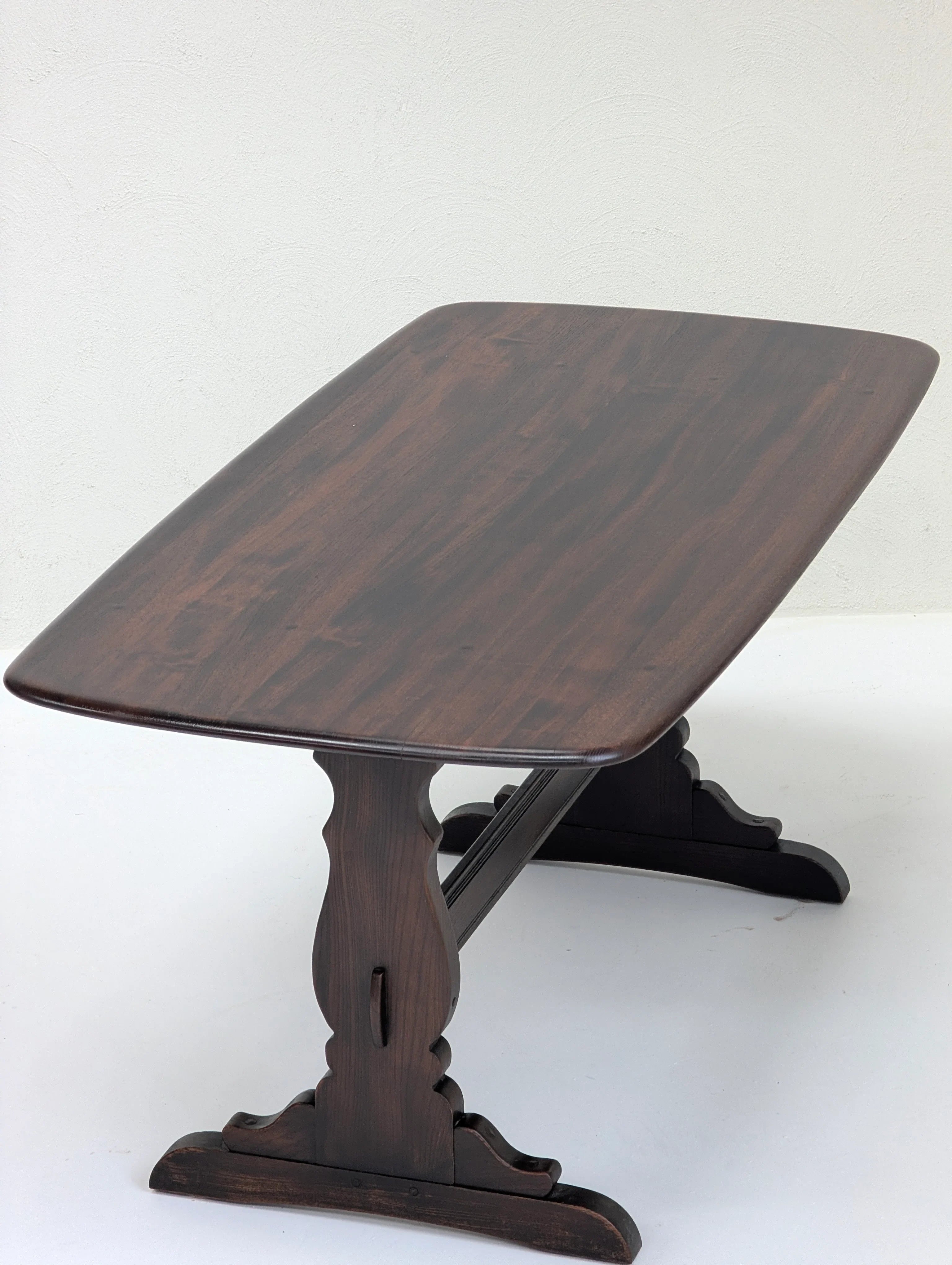 Dark brown wooden rectangular table with curved carved legs on white background