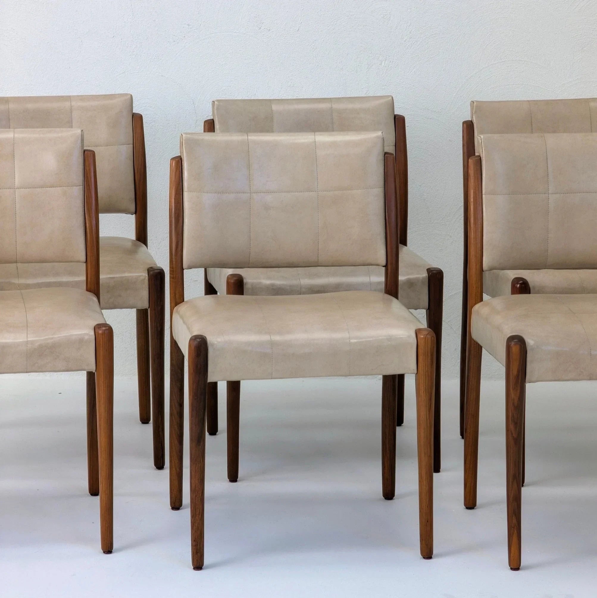 Set of six Fler dining chairs with beige upholstery and blackwood frames, minimalist style