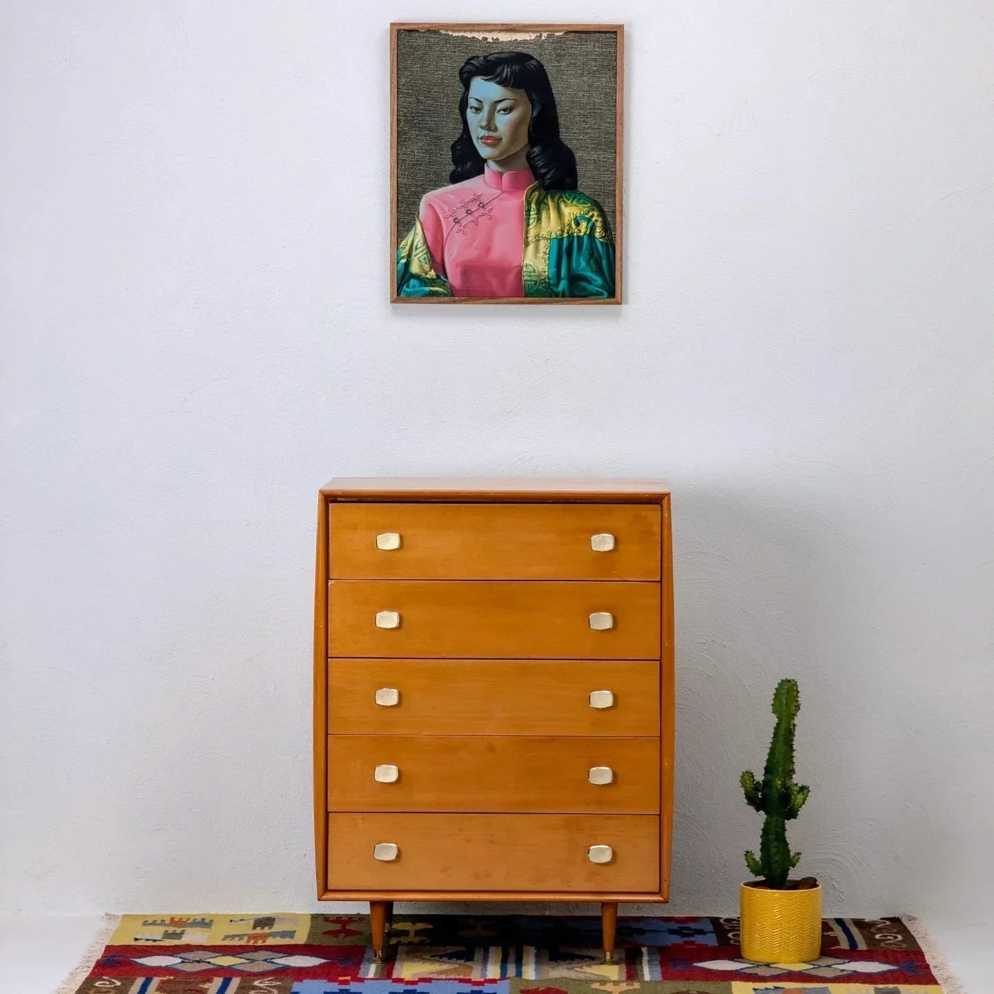 Mid-century oak tallboy chest of drawers by Alrob Furniture, set on patterned rug with a cactus plant