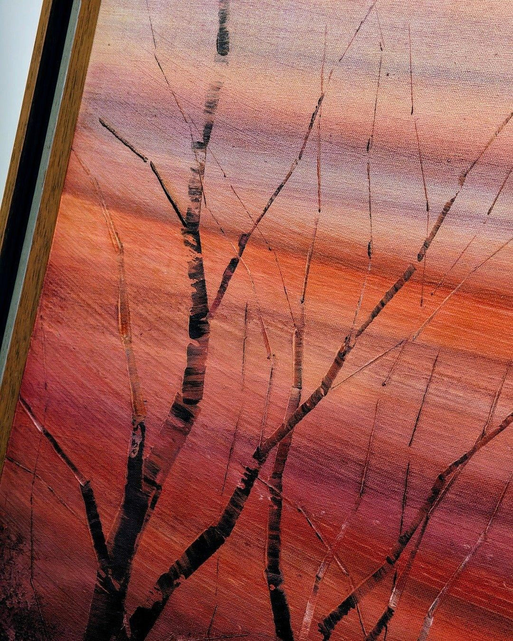Vintage framed oil painting of bare tree branches against a warm sunset sky on canvas