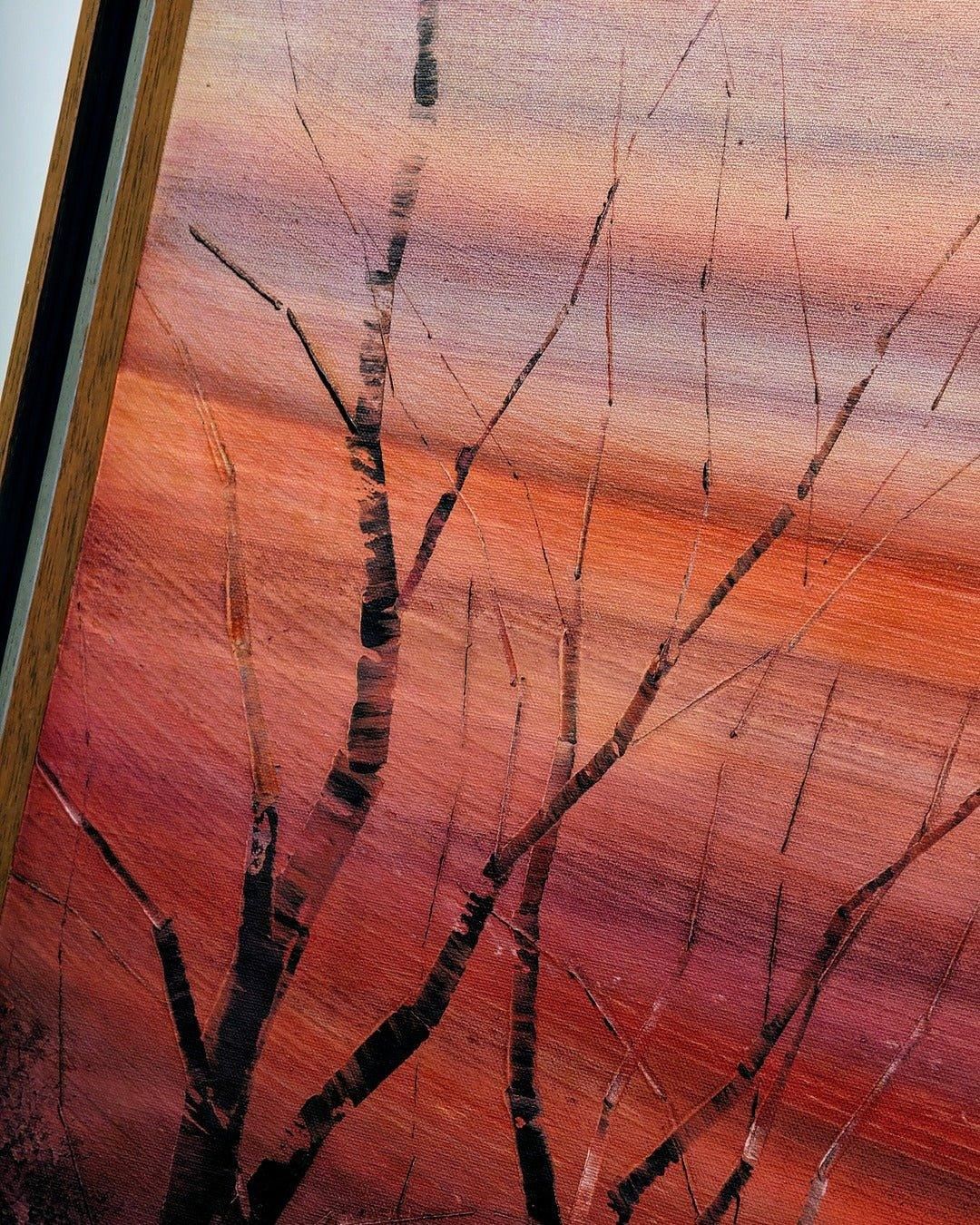 Vintage framed oil painting of bare tree branches against a warm sunset sky on canvas