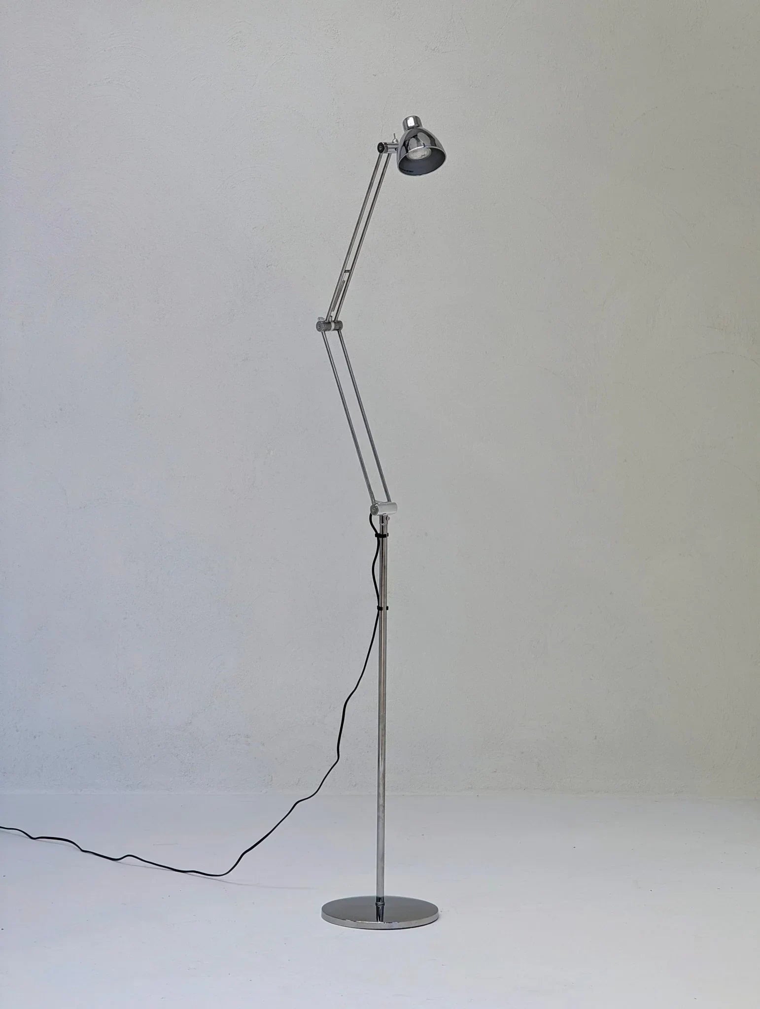 Vintage IKEA Antifoni adjustable chrome floor lamp against a plain gray background