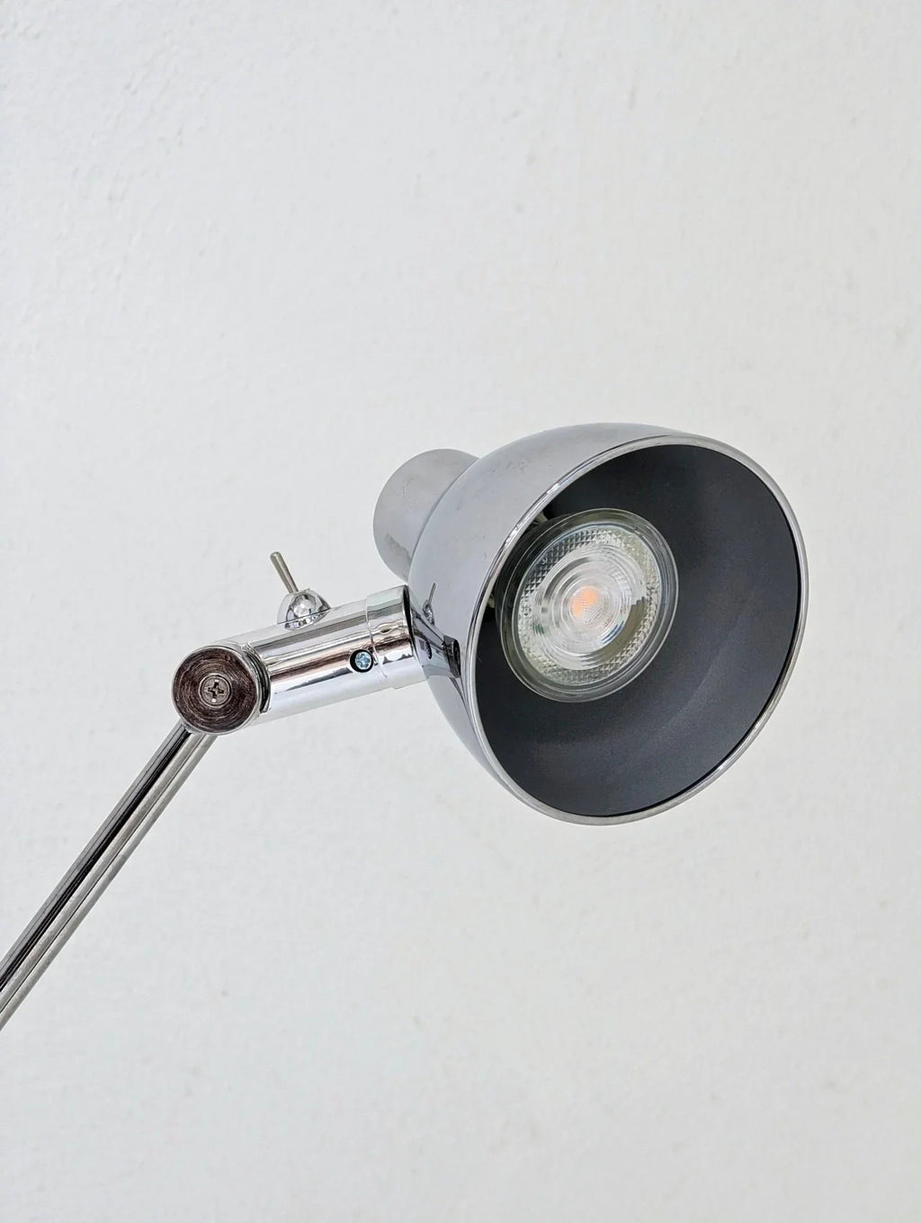 Vintage IKEA Antifoni chrome floor lamp with adjustable arm against a white wall
